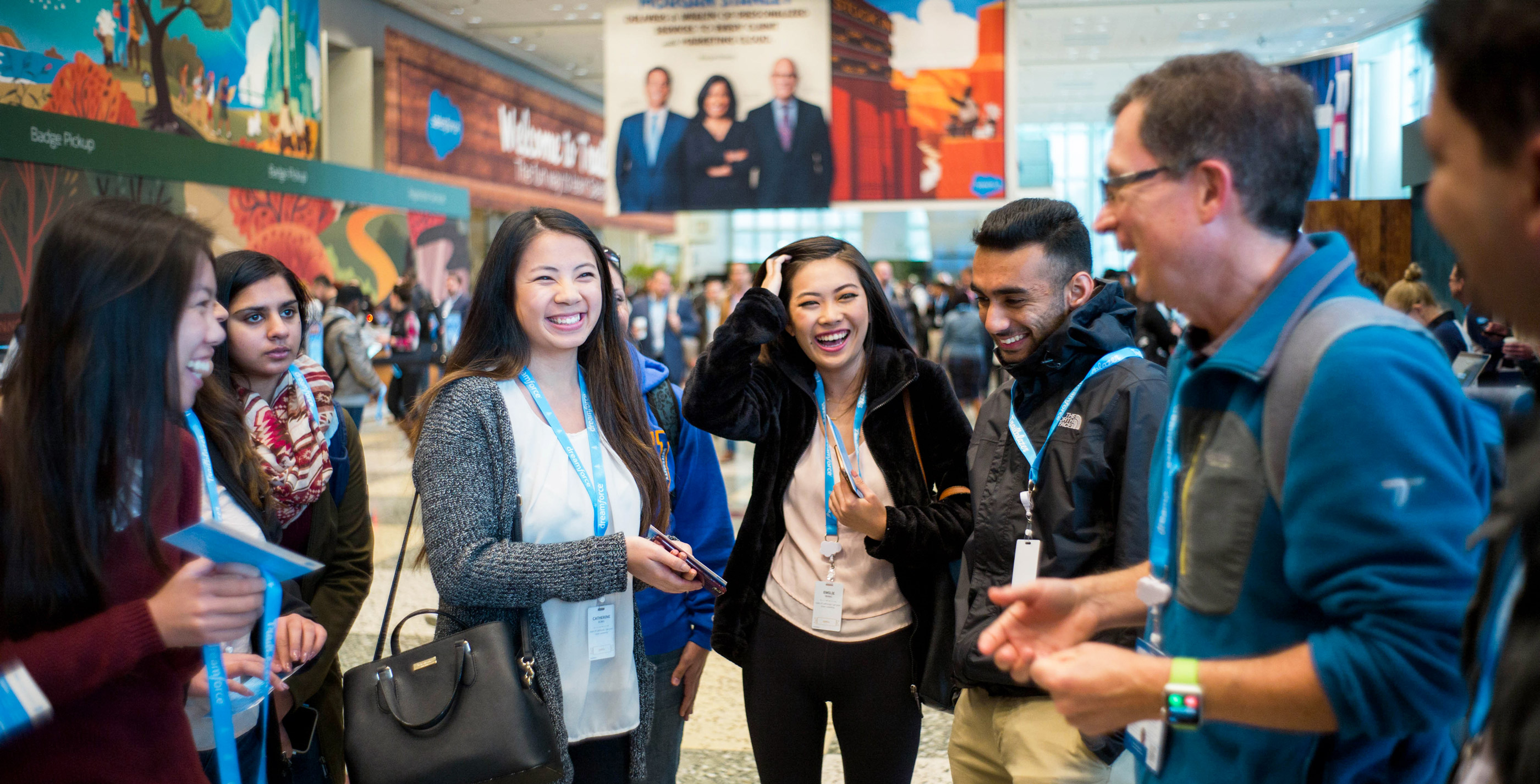 Students at a conference laughing and engaging with fellow students and faculty.