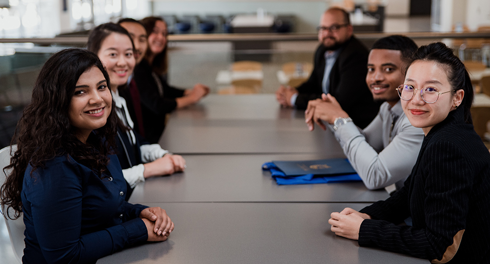 MBA Students Sitting at table MBA Students Sitting at table
