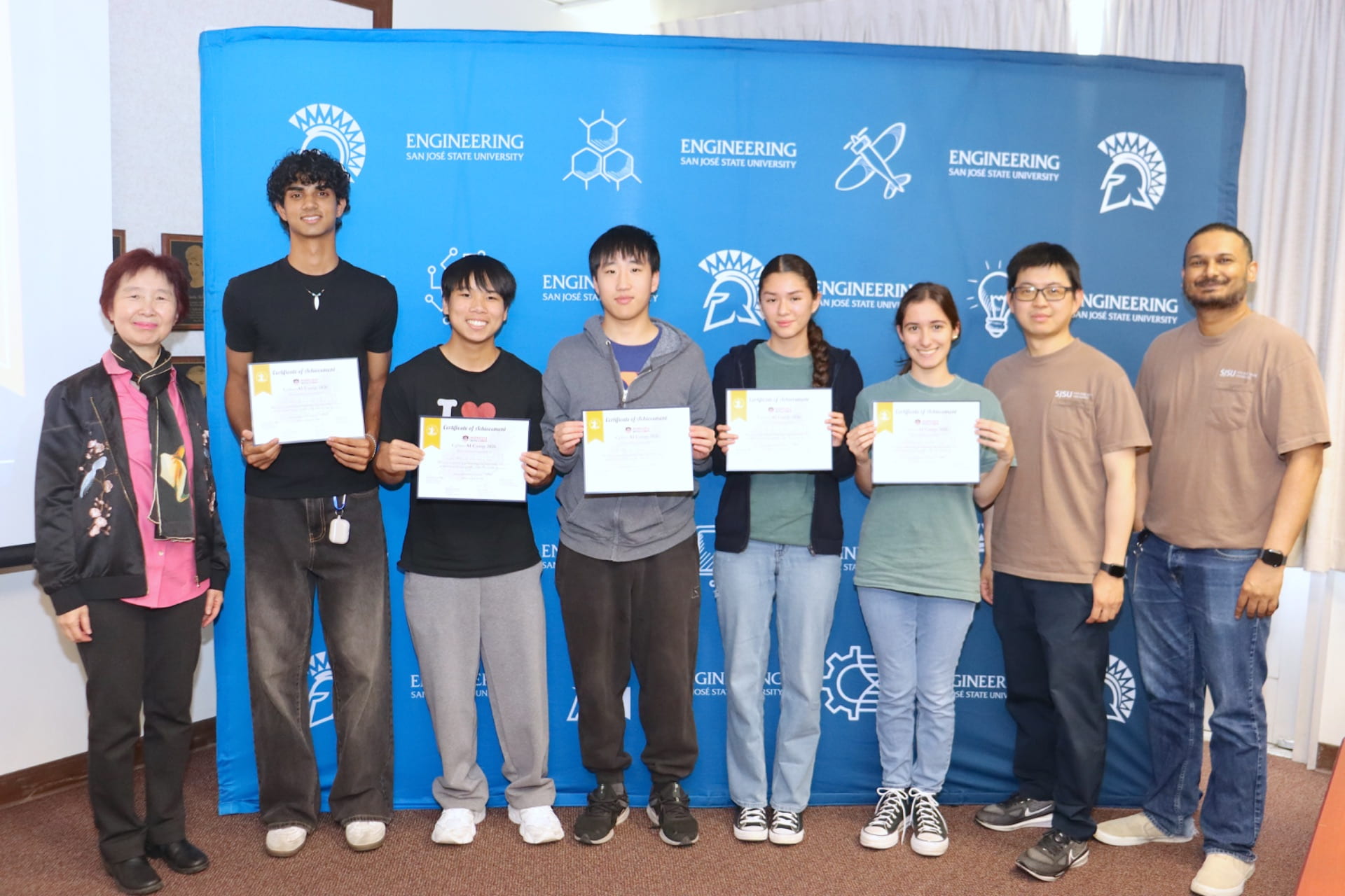 students receiving their CyberAI 2026 camp completion certificates