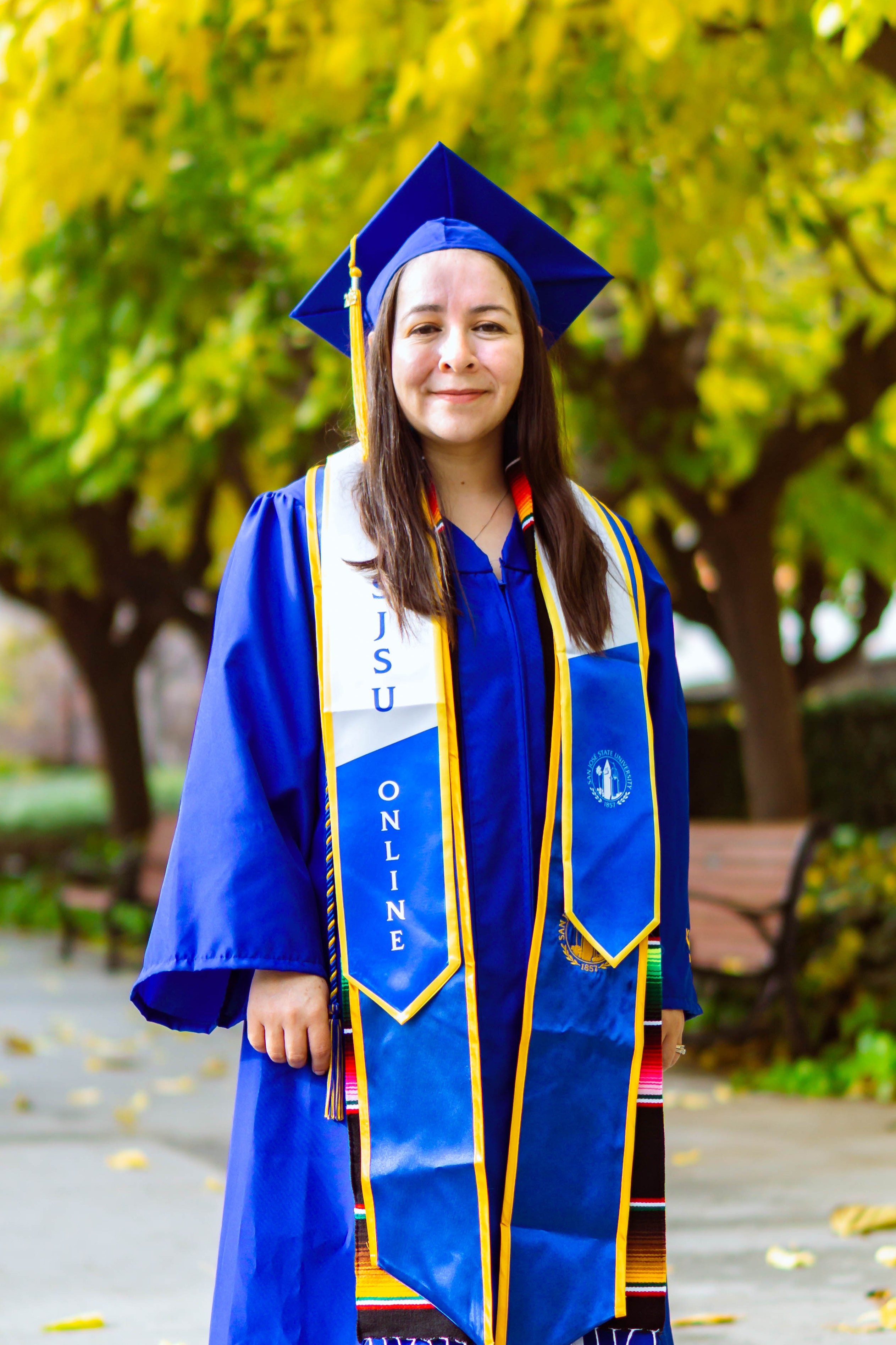 Portrait of female SJSU Online wearing commencement regalia