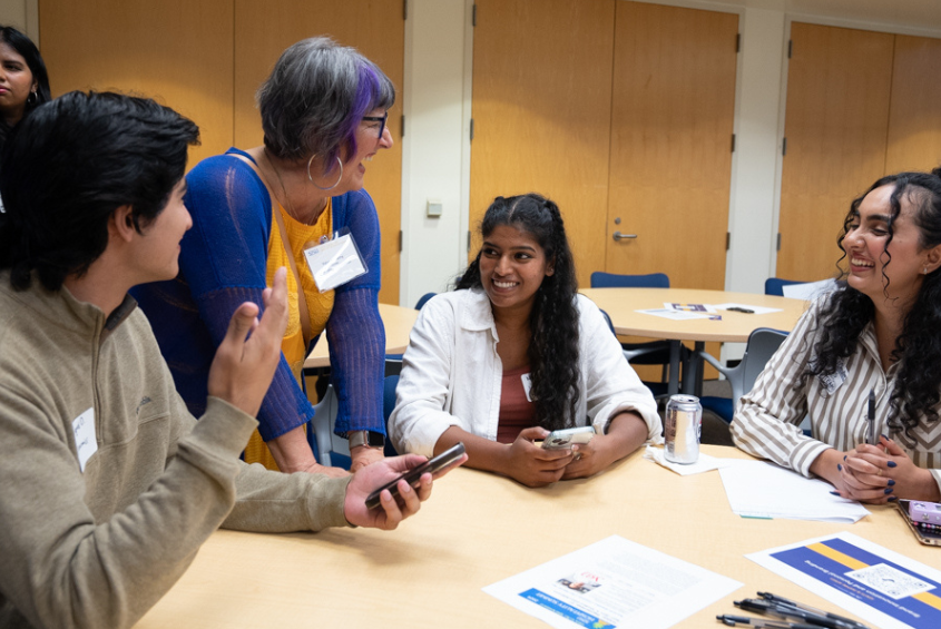 Students and a professor laughing