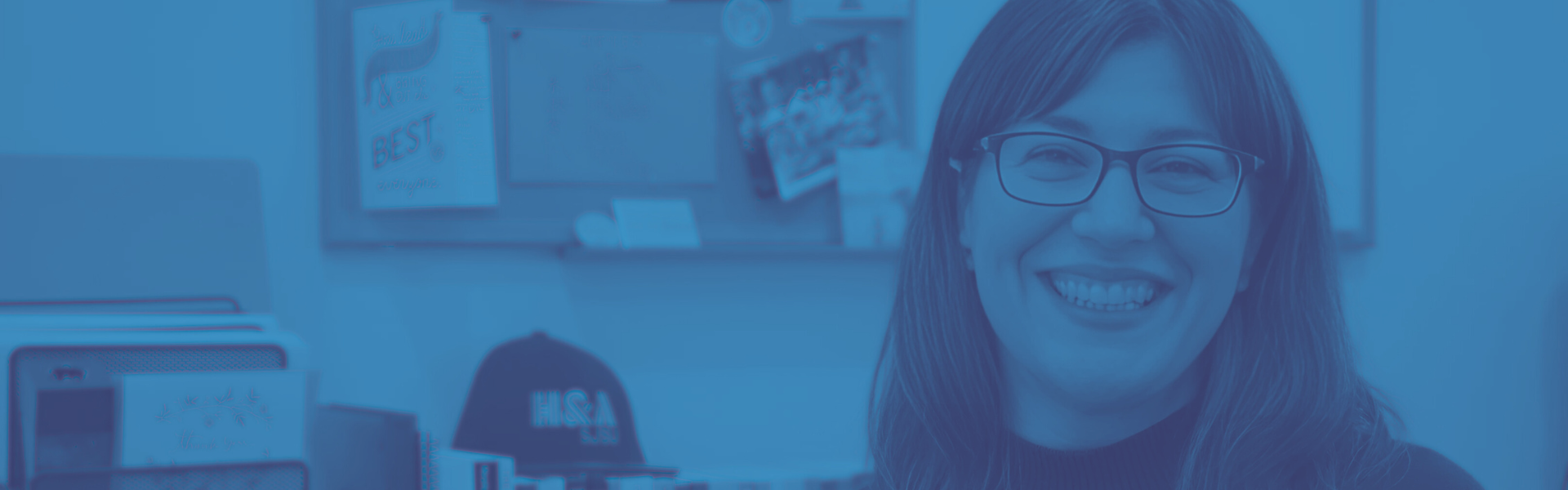 Writing Center director sitting at desk smiling